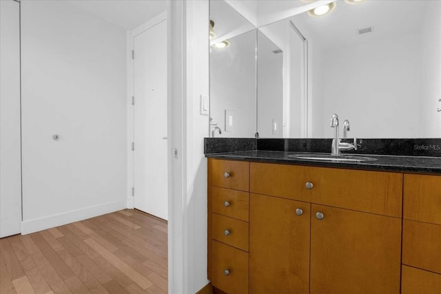 bathroom featuring hardwood / wood-style floors and vanity