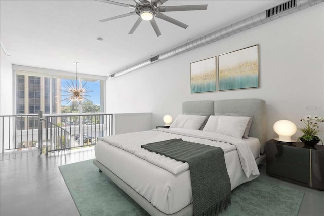 bedroom with ceiling fan with notable chandelier, floor to ceiling windows, concrete flooring, and access to outside