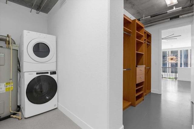 laundry area featuring ceiling fan, stacked washing maching and dryer, and water heater