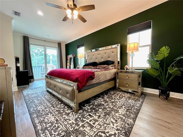 bedroom featuring access to outside, hardwood / wood-style flooring, ceiling fan, and ornamental molding