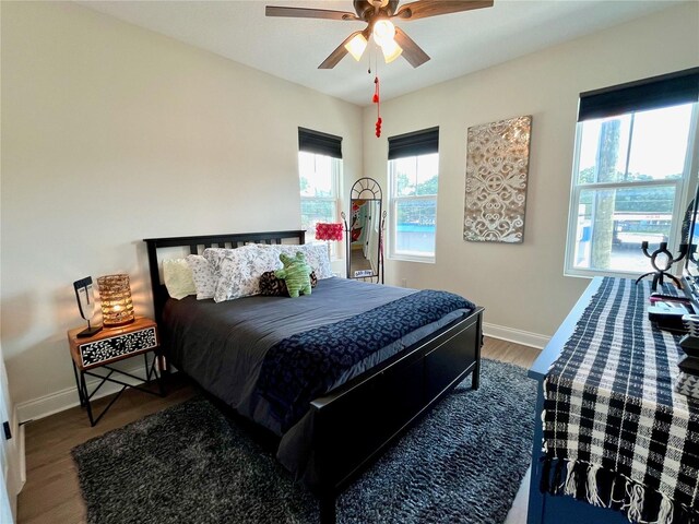 bedroom with ceiling fan and wood-type flooring