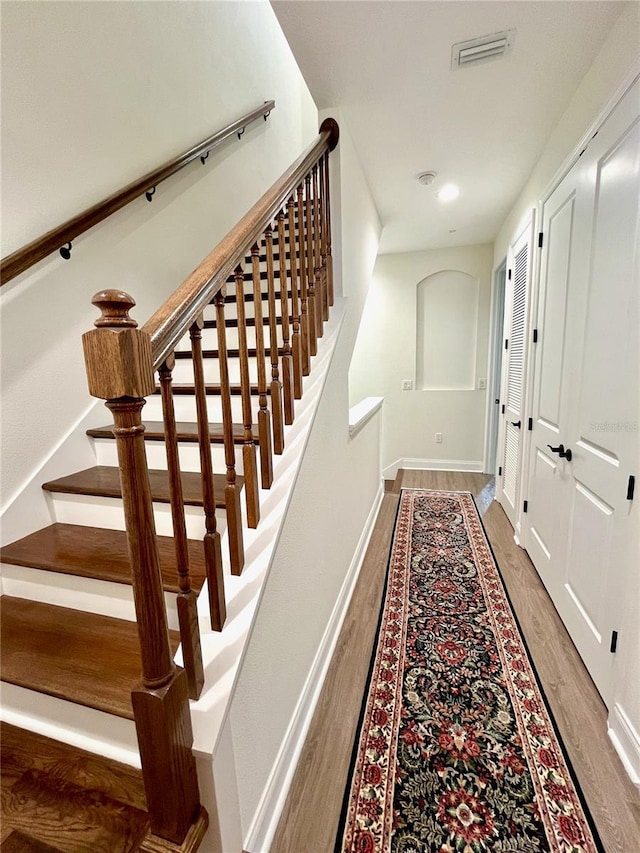 stairway featuring hardwood / wood-style floors