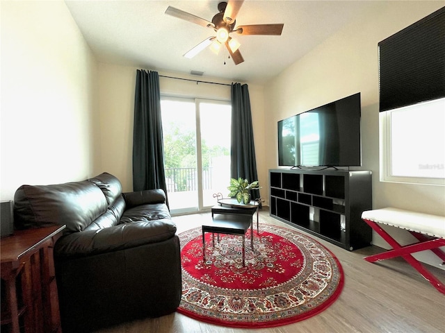 living room with hardwood / wood-style floors and ceiling fan