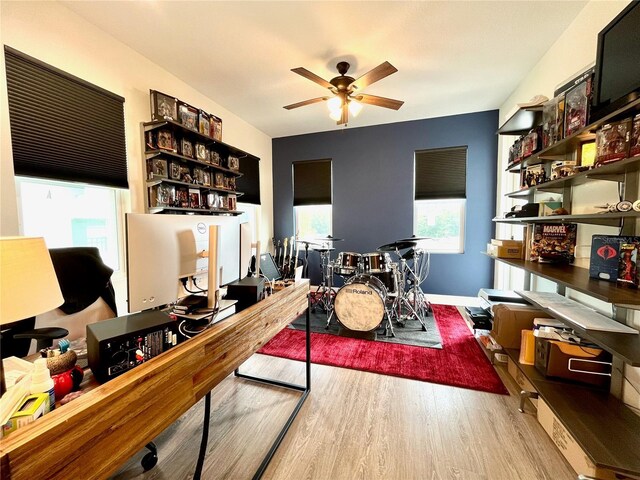 office featuring light wood-type flooring, a wealth of natural light, and ceiling fan