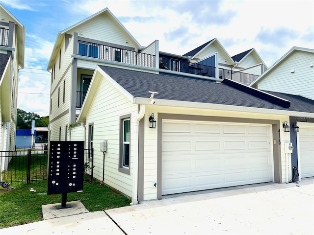 view of front of home featuring a garage and a balcony