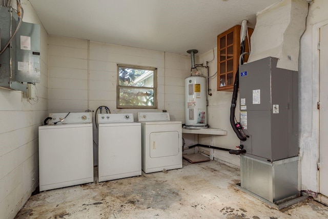 clothes washing area featuring washer and dryer, electric water heater, heating unit, and electric panel