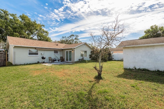 rear view of house featuring a patio and a lawn