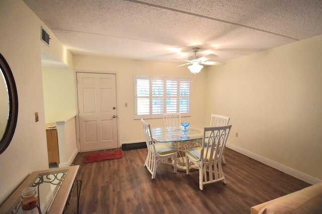 dining area with ceiling fan, dark hardwood / wood-style floors, and a textured ceiling