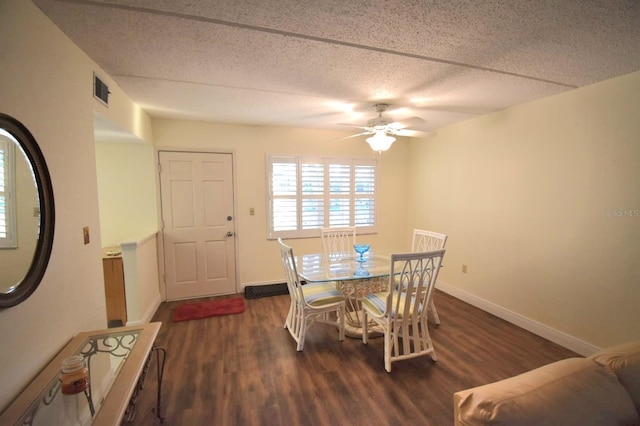 dining space with ceiling fan, dark hardwood / wood-style flooring, and a textured ceiling