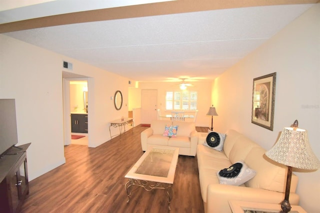 living room featuring ceiling fan and dark hardwood / wood-style flooring