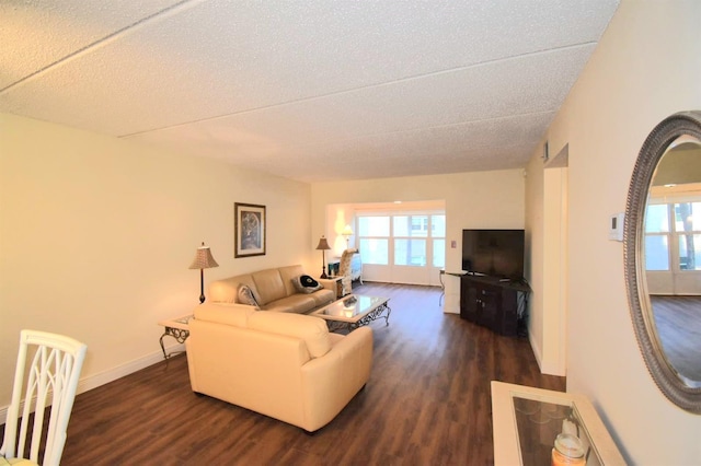 living room featuring a textured ceiling, a wealth of natural light, and dark hardwood / wood-style floors