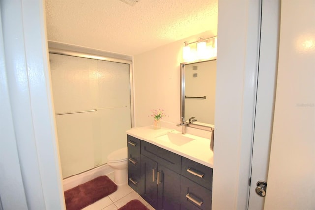 bathroom with tile patterned flooring, a textured ceiling, toilet, vanity, and a shower with shower door