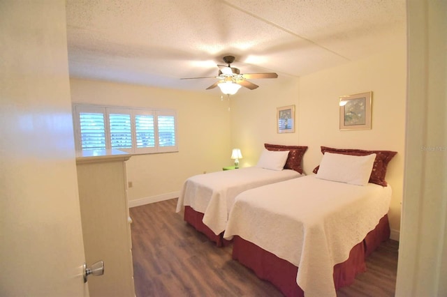 bedroom featuring a textured ceiling, ceiling fan, and dark wood-type flooring