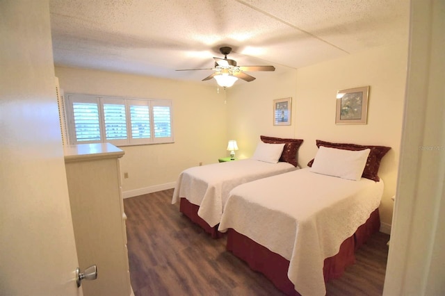 bedroom with a textured ceiling, dark hardwood / wood-style floors, and ceiling fan