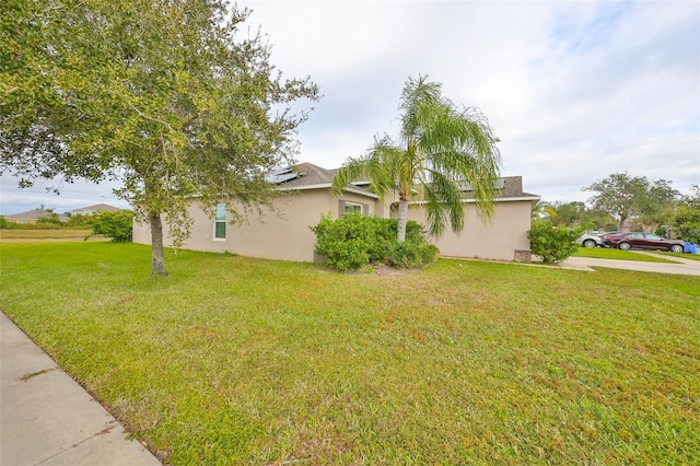 view of side of property with a yard