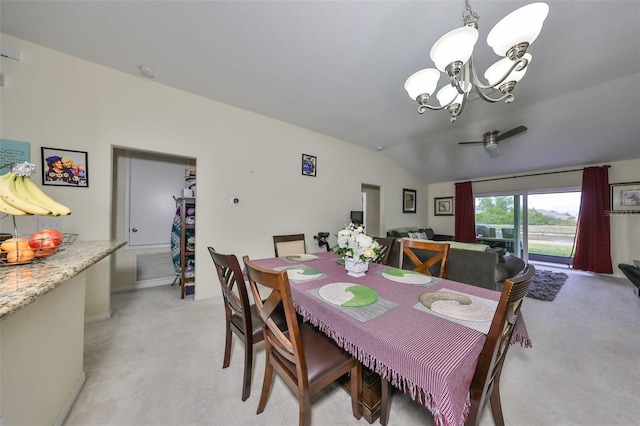 dining space featuring an inviting chandelier, light carpet, and vaulted ceiling