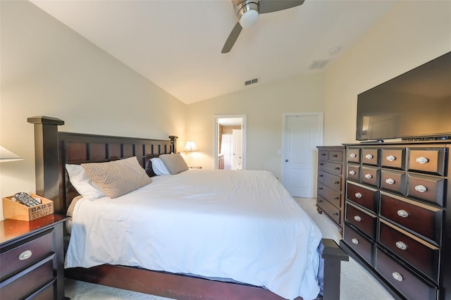 bedroom featuring light colored carpet, vaulted ceiling, and ceiling fan