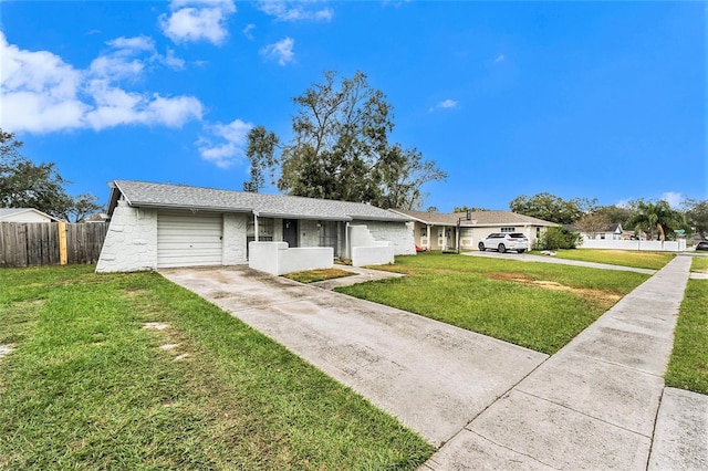 ranch-style house with a garage and a front lawn