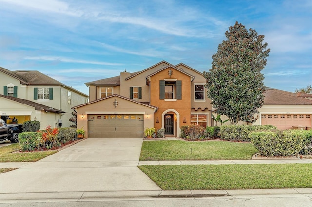 view of front of home with a front yard and a garage