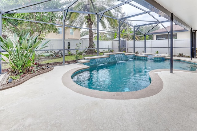 view of swimming pool with a lanai, pool water feature, a shed, an in ground hot tub, and a patio