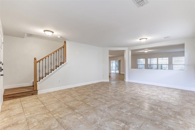 unfurnished living room featuring a textured ceiling