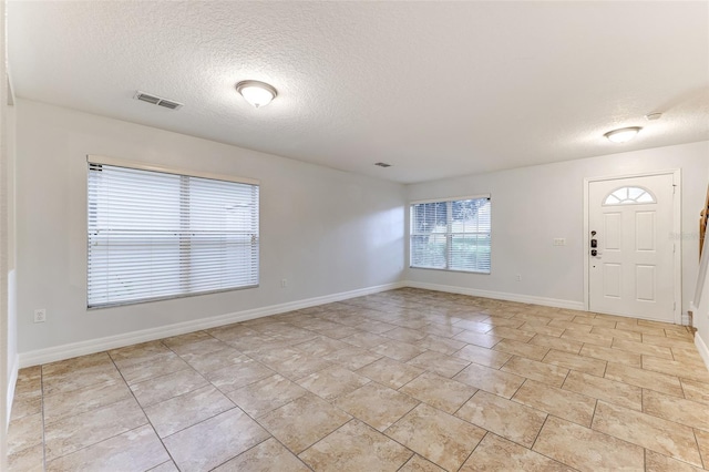 foyer entrance featuring a textured ceiling