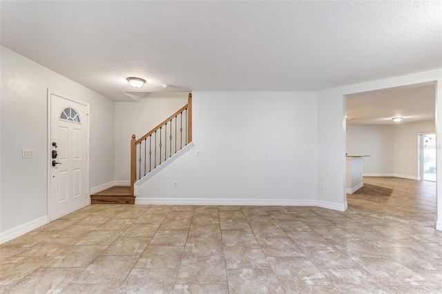 entrance foyer featuring a textured ceiling