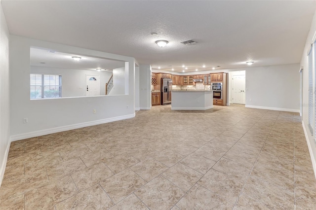 unfurnished living room featuring a textured ceiling