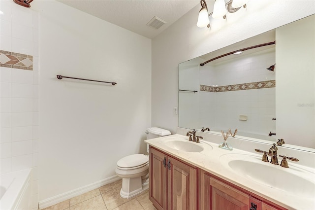 full bathroom featuring tile patterned floors, vanity, tiled shower / bath combo, a textured ceiling, and toilet