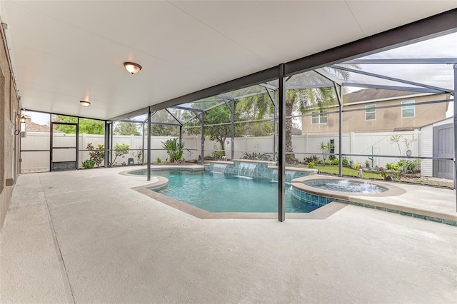 view of pool with pool water feature, a lanai, a patio area, and an in ground hot tub