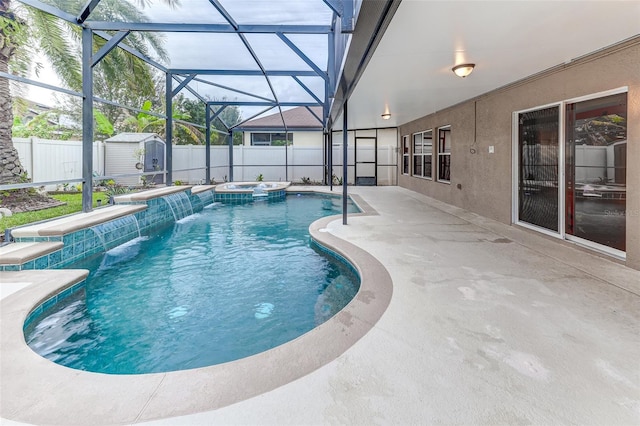 view of swimming pool with an in ground hot tub, a lanai, pool water feature, a patio area, and a storage unit