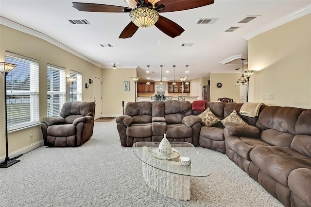 carpeted living room with ceiling fan and crown molding