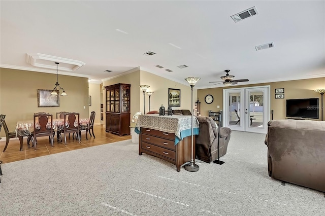 living room with ceiling fan, light colored carpet, ornamental molding, and french doors