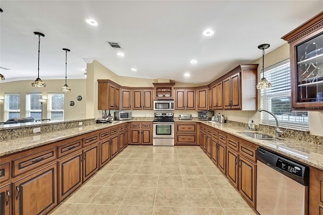 kitchen with lofted ceiling, stainless steel appliances, and hanging light fixtures