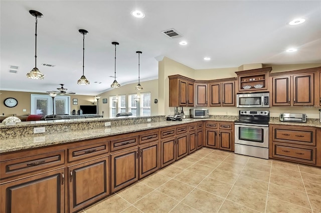 kitchen with ceiling fan, pendant lighting, lofted ceiling, appliances with stainless steel finishes, and ornamental molding