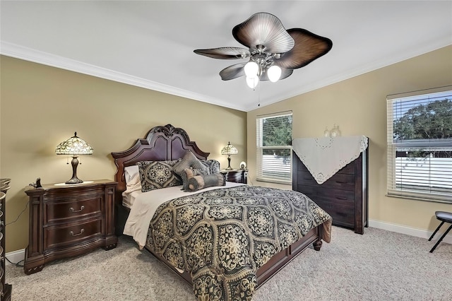 bedroom featuring multiple windows, ceiling fan, crown molding, and light carpet