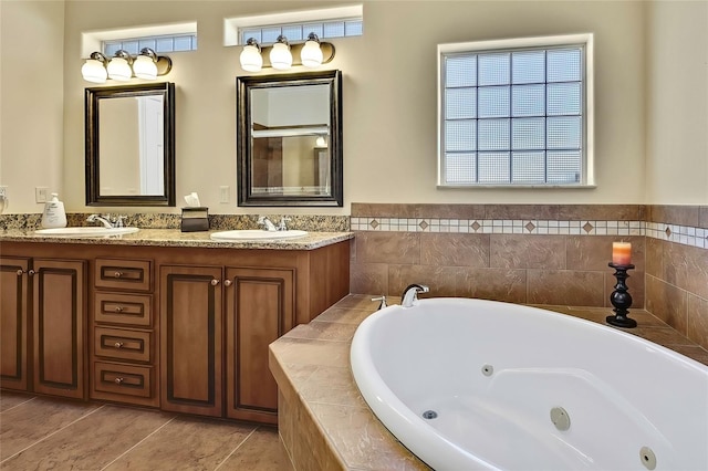 bathroom featuring vanity, tile patterned floors, and tiled tub