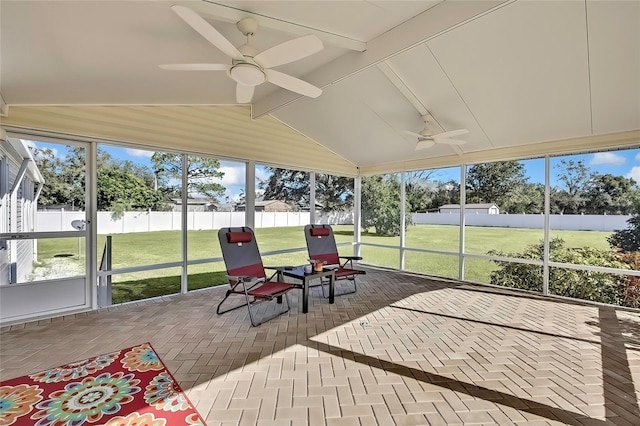 sunroom / solarium featuring lofted ceiling with beams and ceiling fan