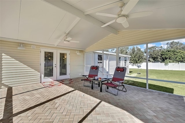 sunroom with ceiling fan, french doors, and vaulted ceiling