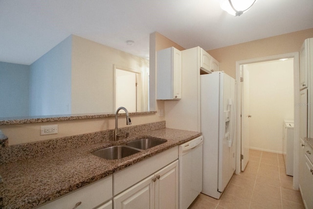 kitchen with light stone countertops, white appliances, sink, white cabinets, and light tile patterned flooring