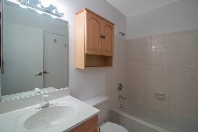 full bathroom featuring vanity, toilet, and tiled shower / bath combo