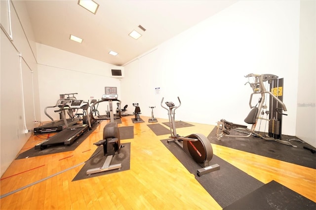 workout area with hardwood / wood-style floors