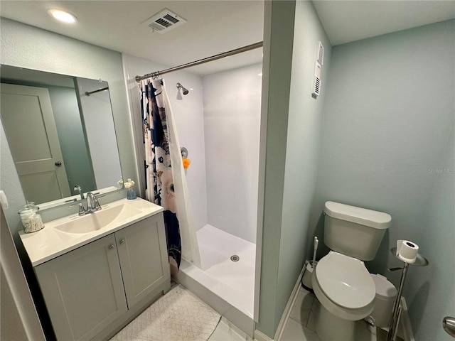 bathroom featuring curtained shower, tile patterned flooring, vanity, and toilet