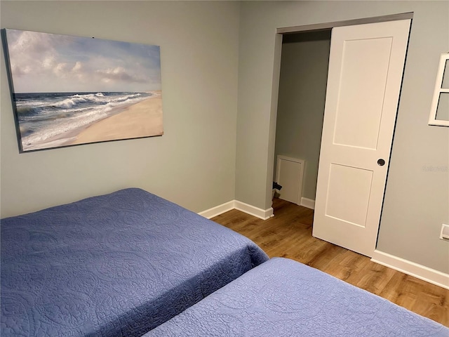 bedroom with wood-type flooring and a closet