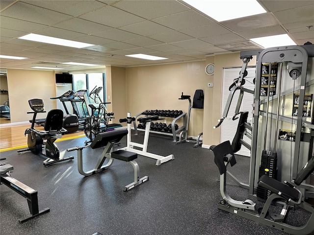 gym with a paneled ceiling