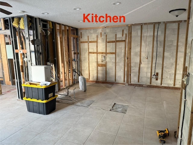 basement featuring a textured ceiling