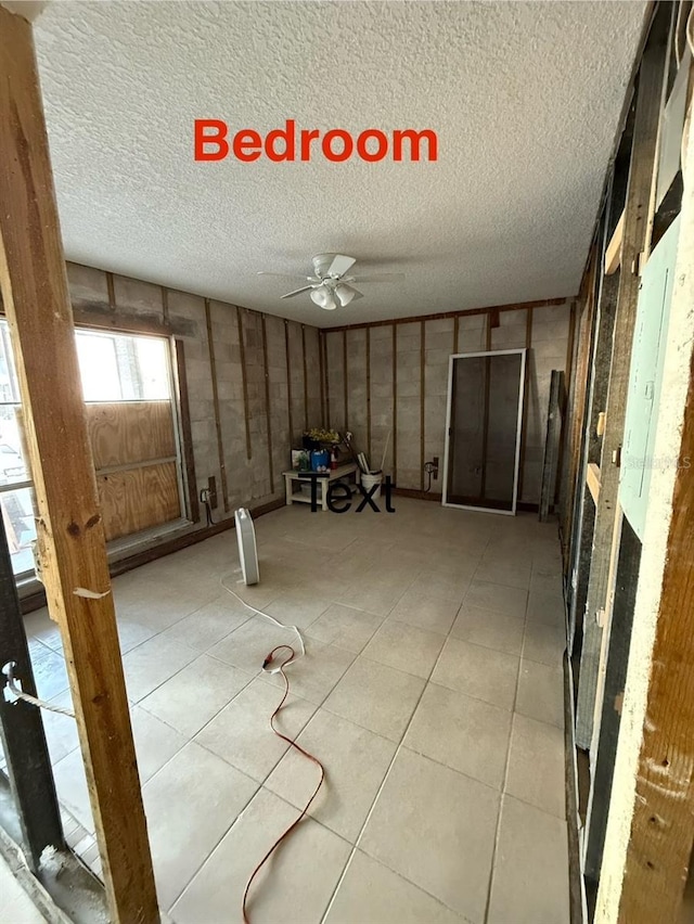 259 Medallion Blvd Unit B, Madeira Beach, FL 33708 - interior space with a textured ceiling, ceiling fan, and light tile patterned floors