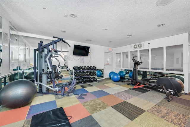 workout area featuring a textured ceiling