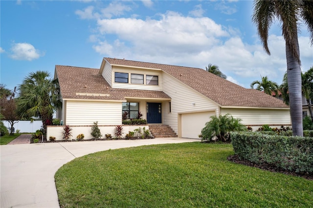 view of front of property featuring a front yard and a garage