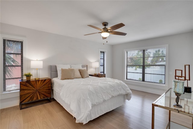 bedroom with hardwood / wood-style floors and ceiling fan